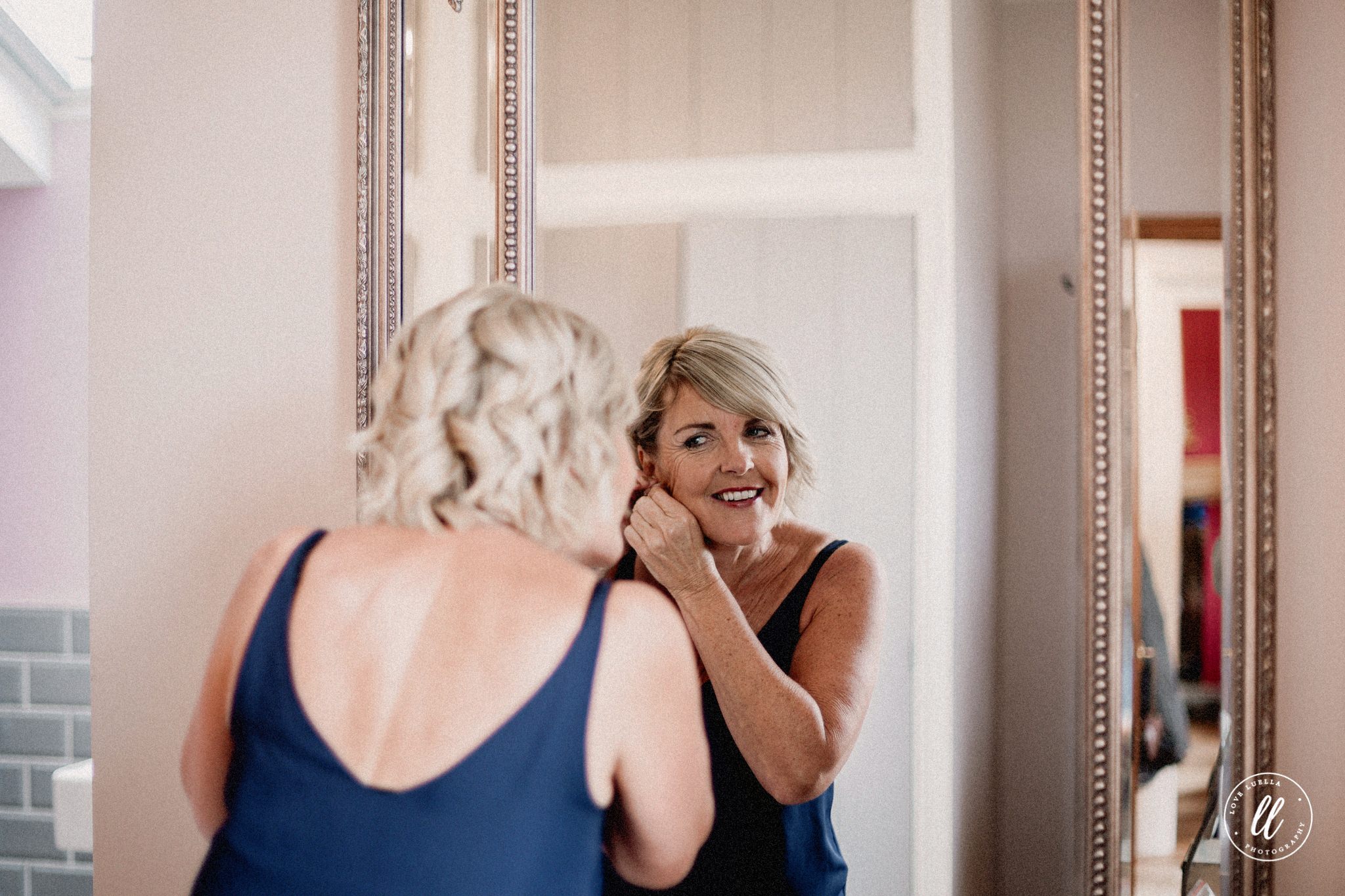 The Brides Mother Putting In Her Earrings