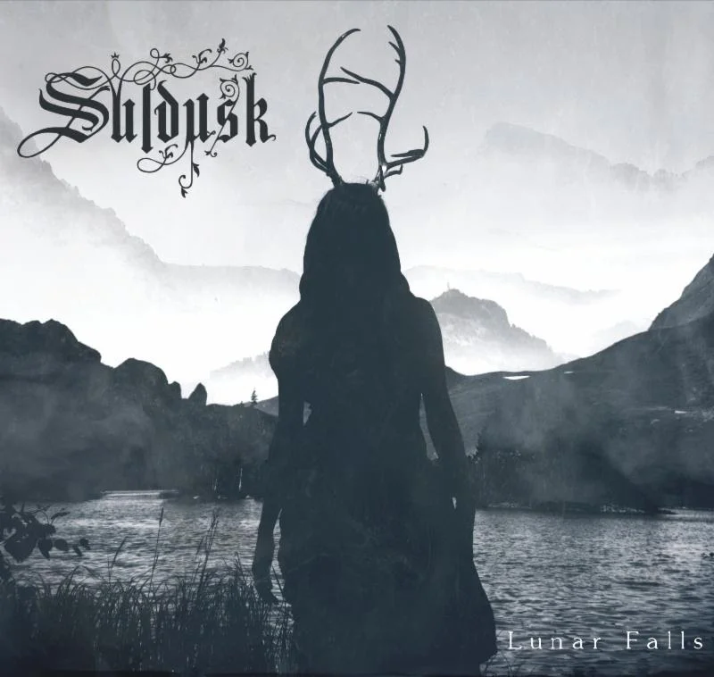 Artwork by Aki Pitkänen, Narikka Photography Hailing from Melbourne, Australia, SULDUSK - a new project led by other-worldly frontwoman Emily Highfield - weaves acoustic tones of dark folk with elements of doom, atmospheric black metal and post rock. SULDUSK is set to release her debut full-length album, entitled Lunar Falls , on April 12, 2019. The album is available for pre-order now via Bandcamp . The album will also be released as a Collector's Edition Digipack-CD (first press, limited to 1000 copies) and LP (limited colored vinyl with poster) via the Northern Silence Productions webshop or Bandcamp page. The limited edition LP is only available via the webshop while supplies last - only 99 copies remaining! Lunar Falls ' undercurrent theme is about living on the margins, and the intolerable suffering and sacrifice in the quest for identity. Nature provides much of the lyrical inspiration as the source of refuge and guidance throughout this quest. Lunar Falls is dedicated to the memory of late singer-songwriter Aleah Starbridge ( Trees of Eternity ). Listeners can get an idea of what mystic sounds SULDUSK has to offer on Lunar Falls via a newly released track, "The Elm" - an adaptation of Aleah and Juha Raivio's track "Sinking Ships". The hair-raising track is available to stream now via YouTube here: https://youtu.be/OqiyvpATii4 Highfield says, "The Elm is an authorized adaptation of Sinking Ships by Trees of Eternity . It is my tribute to Aleah Stanbridge who never lived to see the impact her music has had." Additional streams of equally-haunting tracks "Solus Ipse", "Aphasia", "Three Rivers" and "Catacombs" are also available to stream via Bandcamp , and also via YouTube at the links below: "Solus Ipse" track stream: https://youtu.be/bC8qksTMNjQ "Aphasia" full music video : https://youtu.be/0rF53CTmjDs "Three Rivers" track stream: https://youtu.be/_zzyv_3BbhI "Catacombs" track stream: https://youtu.be/o-pwYR3r5wo With Lunar Falls , Emily Highfield explains that she wants to convey an escape to a soothing and real place. Her organic, earthly approach to music creates an immersive soundscape - a powerful panorama of shimmering guitars, haunting melodies and atmospheric density. Highfield adds, " Lunar Falls is a sonic midnight forest trek - at times beguiling and soothing, and at once harsh and raw. Like nature itself. Bands that inspire me are immersive, honest and risk takers. I'm inspired by and love acoustic-driven and atmospheric/depressive metal - like Agalloch, Opeth, Saor, Unreqvited, Heretoir and Trees of Eternity ." SULDUSK first turned heads a few years ago after frontwoman and then-solo artist Emily Highfield uploaded some of her compositions to Soundcloud. When the melancholic black metal-infused acoustic track "Drogue" ended up reaching over 10,000 plays in less than a month, Highfield knew she was onto something great. This inspired Highfield to create the live and current incarnation of SULDUSK - a chamber metal ensemble which has since been embraced by audiences and underground musicians alike. Lunar Falls was engineered, mixed and produced by Mark Kelson, with additional engineering by Jesse Oberin. The album was mastered by Joseph Carra at Crystal Mastering. Lunar Falls track listing: 1. Eleos 2. Solus Ipse 3. The Elm 4. Aphasia 5. Three Rivers 6. Autumnal Resolve 7. Catacombs 8. Nazaré 9. Drogue 10. Sovran Shrines SULDUSK is: Emily Highfield: Vocals, Guitar Mark Kelson: Guitar, Bass, Keys Glenn James: Percussion Marty O'Shea: Drums Nicky Blackmore and Bryan Murphy: Additional Guitar Francesca Mountford: Cello SULDUSK online: www.facebook.com/suldusk www.instagram.com/suldusk suldusk1.bandcamp.com "Emily Highfield, the sole creator of SULDUSK , has succeeded in creating thoroughly entrancing musical experiences through seamless juxtapositions of contrasting musical styles. Even her vocals are representative of those contrasts - both caustic in their acidity and beautifully ethereal in their clarity." - No Clean Singing "Mysterious, hypnotic, compelling songwriting. Haunting and beautiful, very original - gentle, soothing, and then at times unexpectedly powerful when it conjures other-worldly dark screams from the collective sub-conscious - like Mother Nature venting her fury!" - David Hirschfelder, Internationally award-winning soundtrack composer "Varyingly described as acoustic Black Metal, Blackgaze or Doom Folk, SULDUSK have a sound that is entirely their own and utterly captivating... While no comparison can truly capture the magic of SULDUSK , fans of Opeth 's 'Damnation' album are likely to be impressed." - Overdrive Magazine