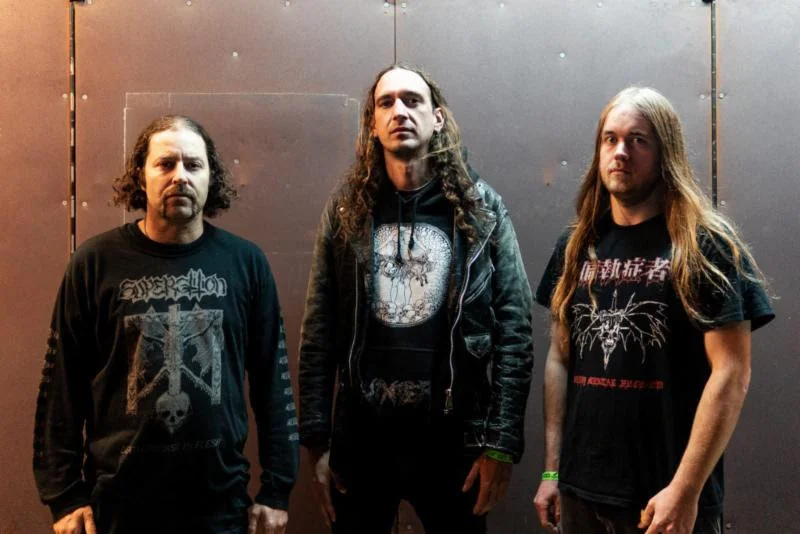 Photo by Ron Yamasaki Bay Area death metal trio NECROT will take their hymns of decay to the streets again, beginning with two shows in Calgary and Winnipeg respectively this weekend. In August, the band will quake the stage of this year's Tankcrimes Takeover alongside labelmates Kicker, Cliterati, and Deathgrave as well as Vert & Distort Fest with Argentavis, Nerve Exposure, and more. In September, NECROT will crush Northwest Hesh Fest before taking on a nine-date trek through Australia with Melbourne death practitioners, Faceless Burial. The tour runs from September 26th through October 6th. From there, the band will play Asakusa Deathfest in Japan alongside Undergang, Pestilence, Phrenelithand more. See all confirmed dates below. NECROT: 7/19/2019 Dickens - Calgary, AB 7/20/2019 The Good Will - Winnipeg, MB 8/23/2019 Tankcrimes Takeover @ Eli's - Oakland, CA w/ Kicker, Cliterati, Deathgrave 8/24/2019 Vert & Distort Fest @ RampArt Skatepark - Arcata, CA 9/21/2019 Northwest Hesh Fest @ Dante's - Portland, OR w/ Faceless Burial: 9/26/2019 Secret location - Melbourne, VIC 9/27/2019 The Tote Hotel - Melbourne, VIC 9/28/2019 Valve Bar - Sydney, NSW 9/29/2019 The Basement - Belconnen, ACT 10/02/2019 The Hamilton Station Hotel - Islington, NSW 10/03/2019 Vinnies Dive Bar - Southport, QLD 10/04/2019 The Flamin Galah - Brisbane City, QLD 10/05/2019 The Boston - Perth, WA 10/06/2019 208 - Perth, WA 10/13-14/2019 Asakusa Deathfest @ Gold Sounds - Tokyo, JP NECROT continues to tour in support of their critically-lauded Blood Offerings full-length, released via Tankcrimes in 2017. Captured by Greg Wilkinson (Autopsy, High On Fire) and mastered by Brad Boatright (Obituary, Vastum), the record earned the #29 spot on Billboard's Hard Rock Chart and #52 on Billboard's New Artist Chart upon its first week of release. Blood Offerings earned year-end accolades from the likes of Decibel Magazine and Revolver and continues to reap the praise of fans and critics globally. NECROT's Blood Offering s is out now on CD, digital, vinyl, and limited deluxe cassette edition. Find physical orders at THIS LOCATION . Stream Blood Offerings in full at THIS LOCATION where you can also purchase the record digitally. Forged in 2011, NECROT - founded by current and former members of Acephalix, Vastum, Saviours, and more - unleashed their The Labyrinth full-length in 2016 via Tankcrimes. Spewing forth eight tracks amassed from three hard-to-find and long out-of-print demo tapes, the record reaped critical acclaim from fans and media alike compelled by the band's unrepentant Autopsy, Bolt Thrower, and Sacrilege worship. "Blood Offerings is all old ground, but it is hallowed earth. We've heard everything played on this album before, but we've never heard it played quite like this. If you're that curmudgeon who keeps saying nothing can displace your aging death metal album collection, it might be finally time to buy a new record." - Decibel "Packed with killer riffs, thunderous blast beats and the death-defying leads of Saviours guitarist Sonny Reinhardt, the debut album from this hotly touted Oakland death metal trio bristles with a raw intensity that's frequently lost in the modern era of triggered, overproduced extremity. By keeping it real, NECROT keep it awesome." - Revolver "Metaphorically, it's like putting your ear up to the chest of a rotting corpse and listening to the parasites eat it from the inside out. NECROT has recorded an album so putrescent you can almost smell it." - Paste Magazine http://www.facebook.com/cyclesofpain http://www.tankcrimes.com http://www.facebook.com/tankcrimes http://www.tankcrimes.merchtable.com