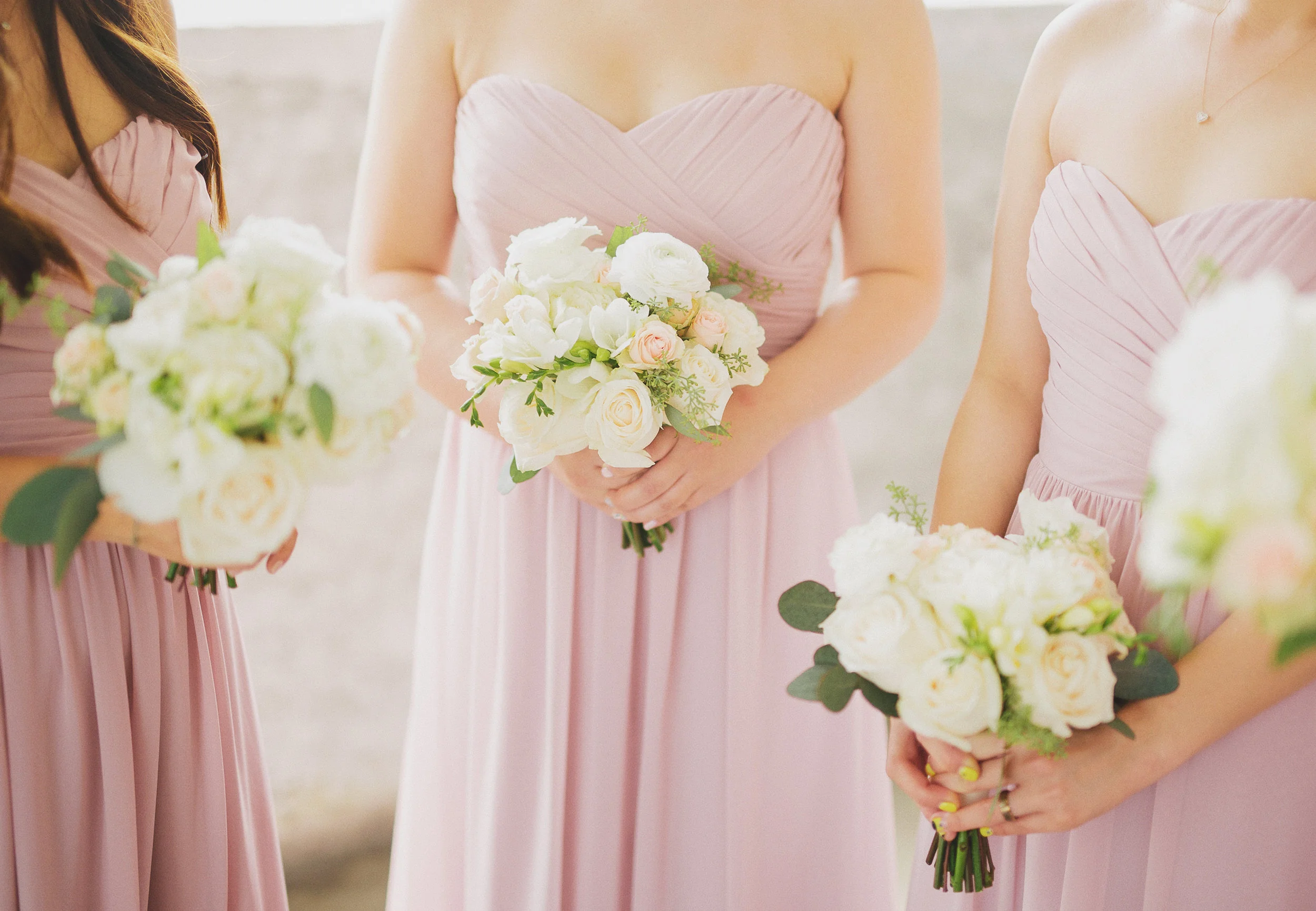 The bridesmaids carried ivory and blush flowers with hints of green to compliment the bride and their blush dresses.
