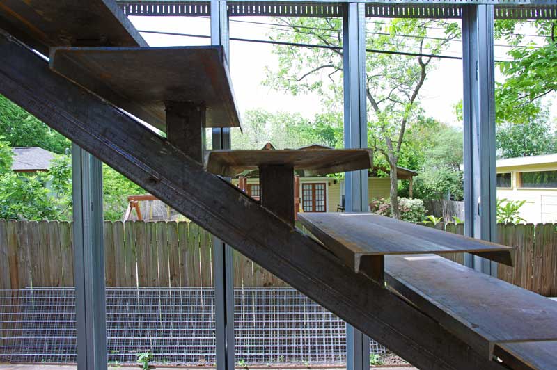 Staircase detail. C-channel used for steps. The initial plan was to install base plates, then finish the steps with wood. However, we had a lot of C-channel laying about and it really does tie the staircase with the rest of the structure.