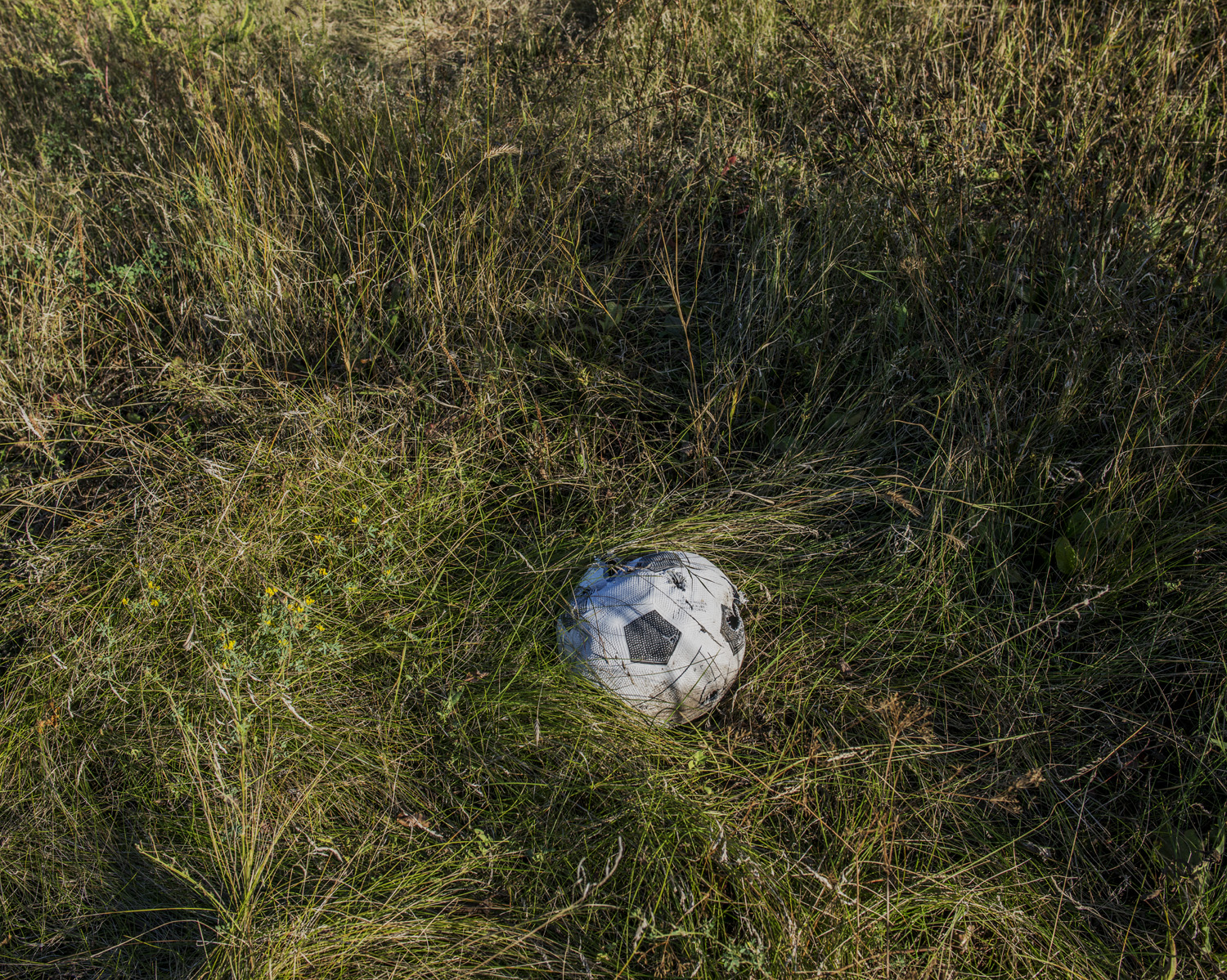 A soccer ball punctured by shrapnel in the village of Pisky. "Everybody wants to stop this war, everybody wants peace." -Giorgiy, 68, Anatol