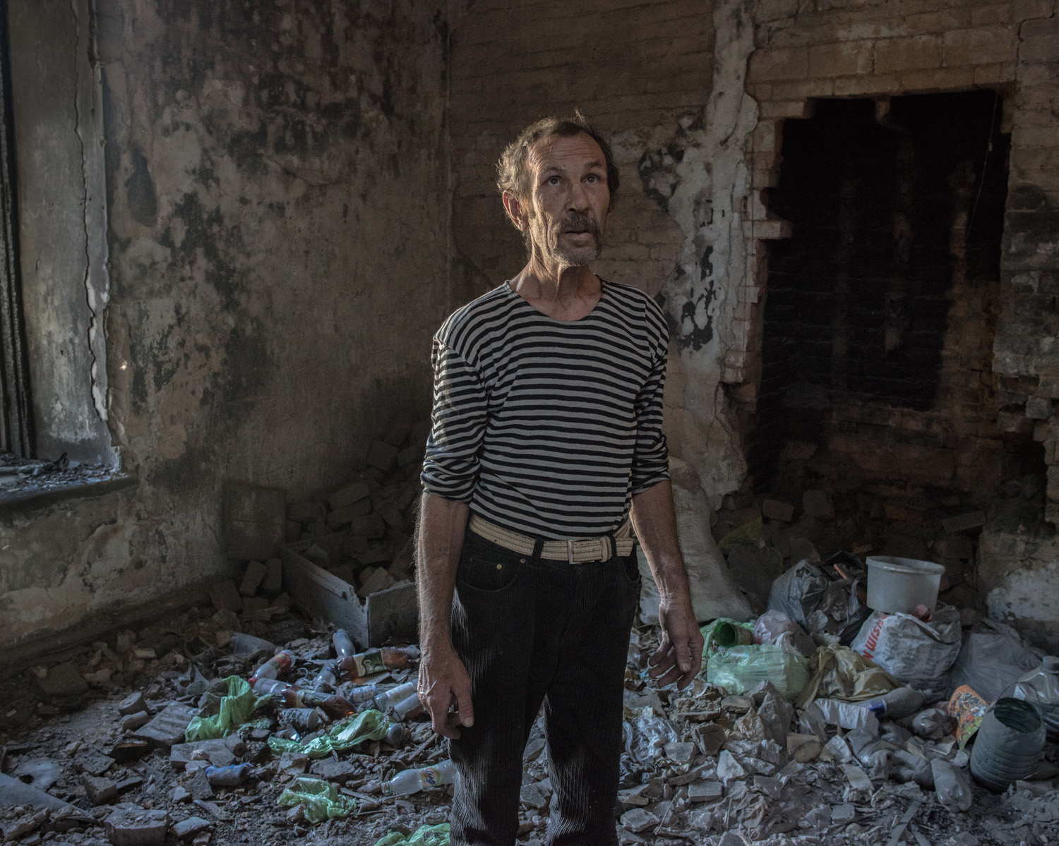 "My apartment was shelled, I was outside cooking when it happened. I came in and I was shocked, everything was on fire, everything was destroyed. Now I live in a smaller apartment down the hall, my neighbor gave me a sofa and table to use. My documents were destroyed in the explosion. Now I only have photocopies, if I can make a little money I'll try to get a new passport made if it's possible." -Sergei, Avdiivka