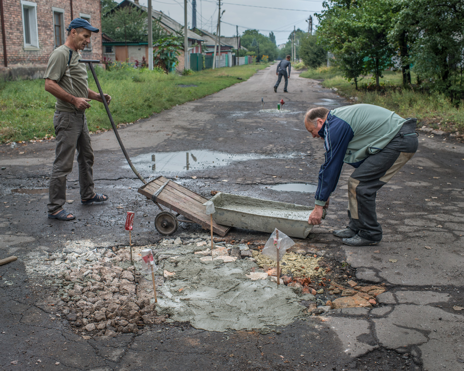  "We repaired this pothole a year ago, now we're repairing it again. Prices are going higher and it's very hard for young people to find work. I worked in the coal mine before I retired. This town was built around coal mines, but when the war started