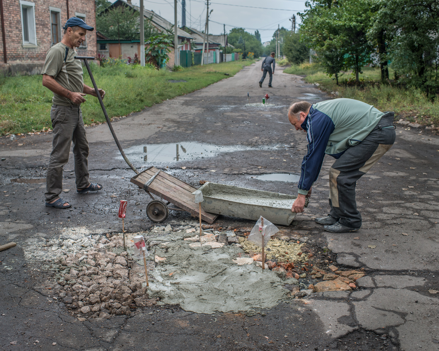 "We repaired this pothole a year ago, now we're repairing it again. Prices are going higher and it's very hard for young people to find work. I worked in the coal mine before I retired. This town was built around coal mines, but when the war started a lot of people left. Nobody knows if the ceasefire will last but I hope the shelling will stop." -Victor, 62, Novoradivke.