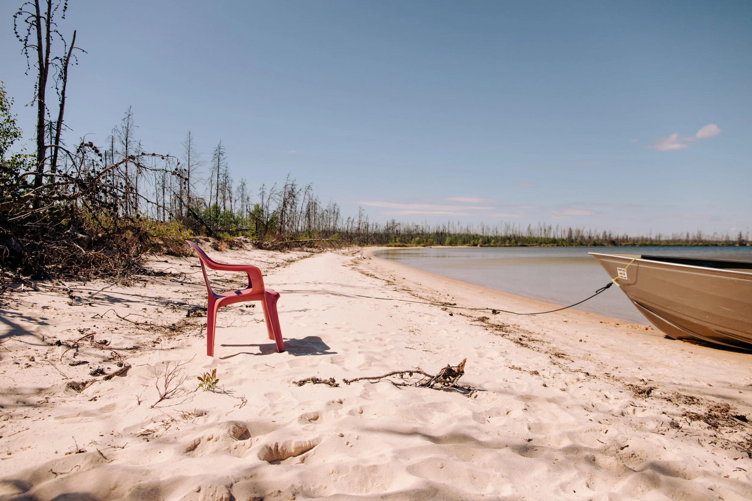  Desperate for beach chairs this pink plastic non folding chair gets a trip to one of the many sandy beaches on Careen lake for the day   