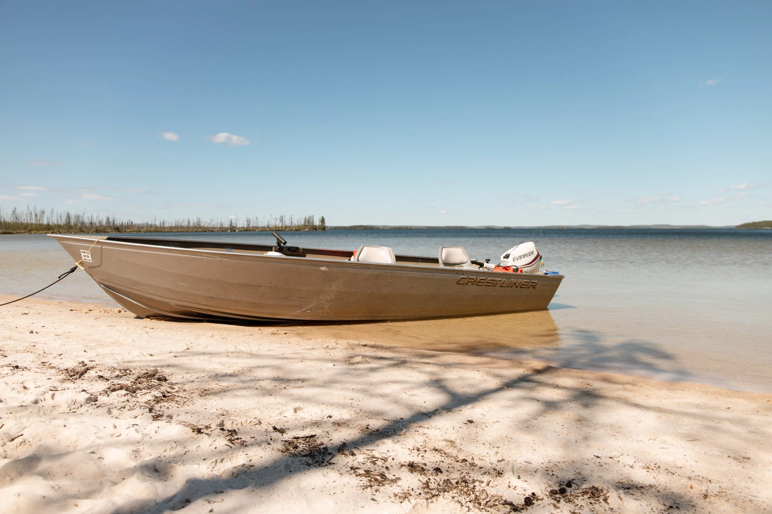  Our boat sits in the water tied to shore 