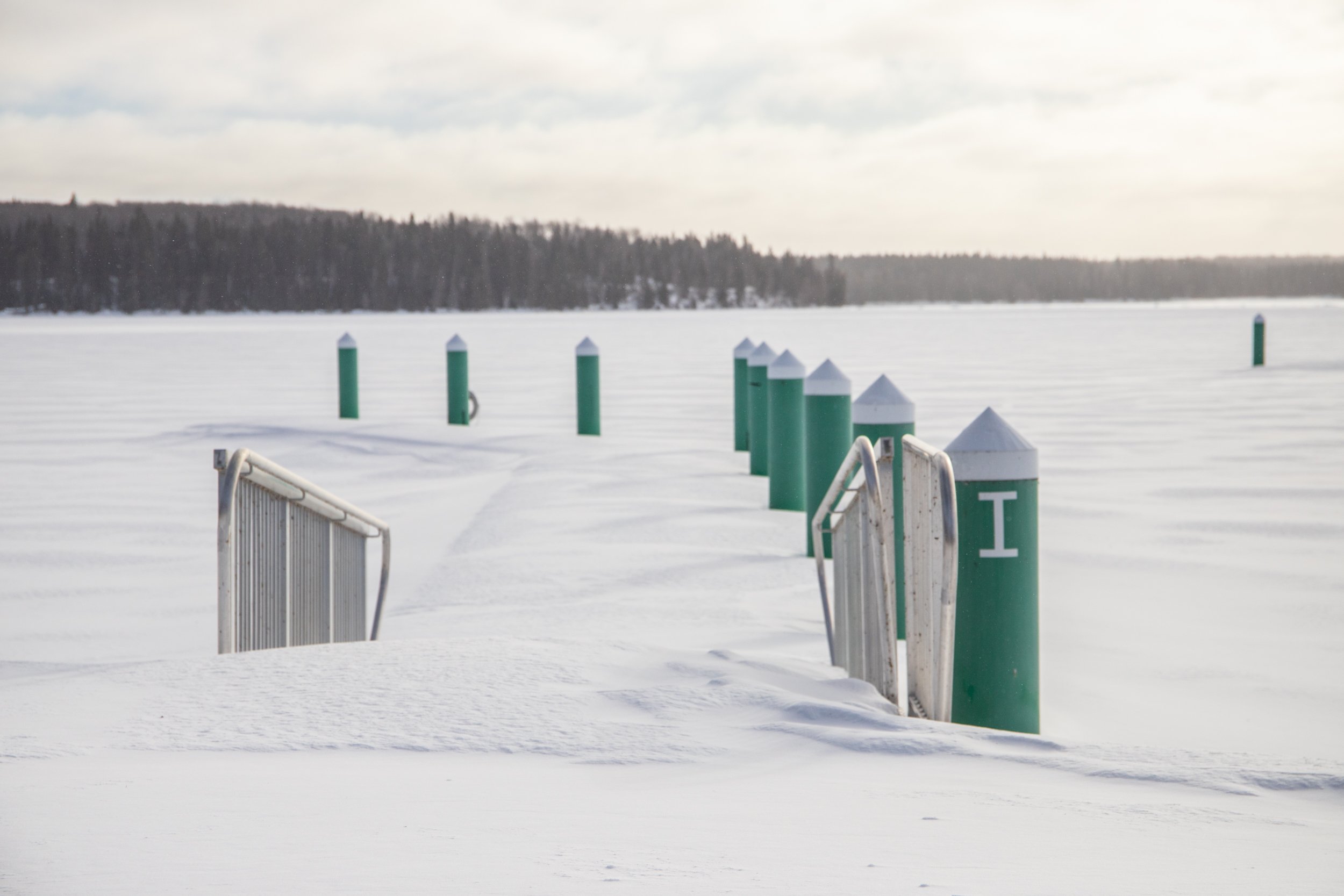A snow covered dock marina at Waskesiu Lake