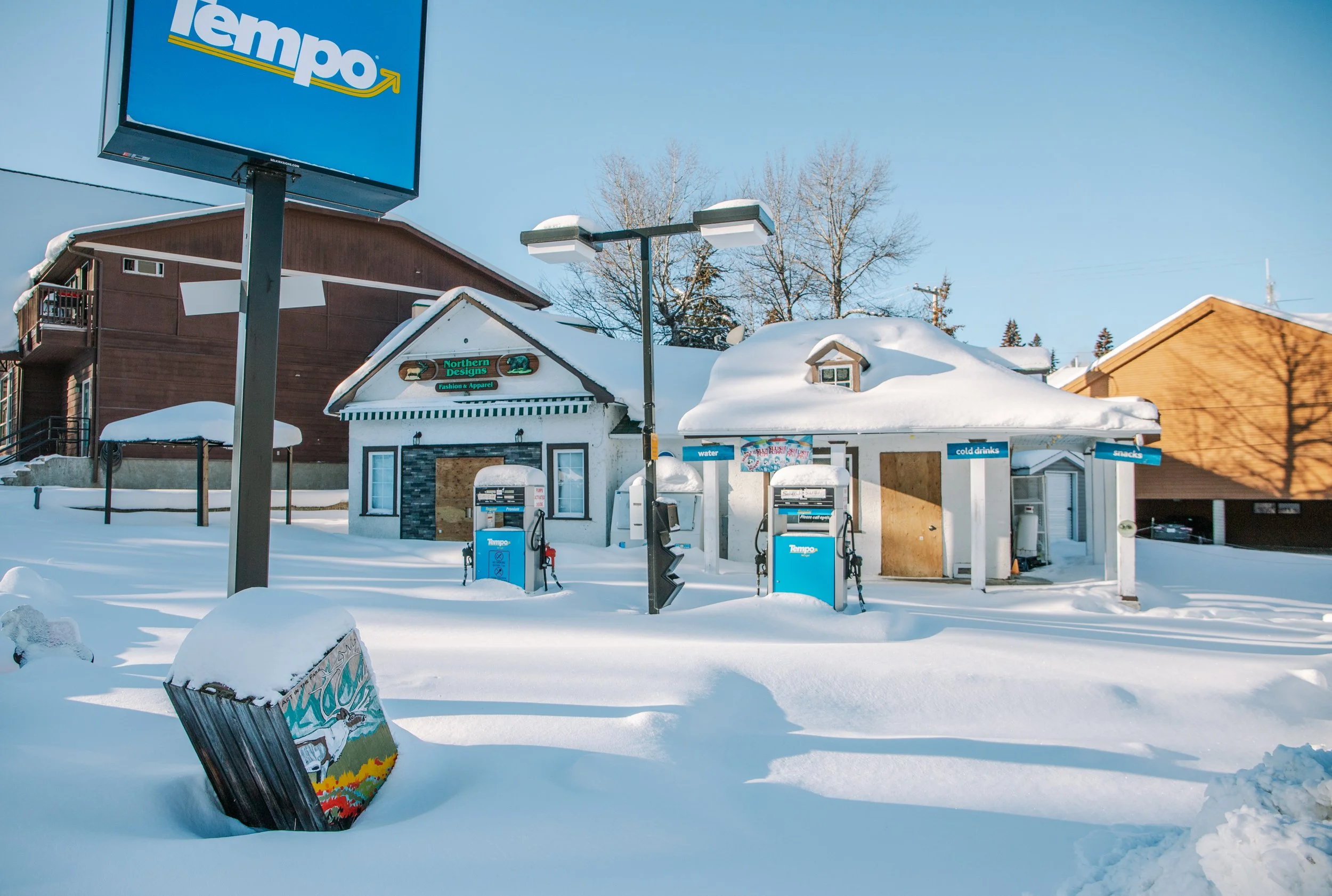A deserted, snow covered Tempo gas station out of service for the winter