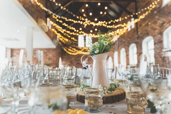 A wider view of the wedding reception room. Flowers, tables, lights, bokeh, vases…. ALL the beauty