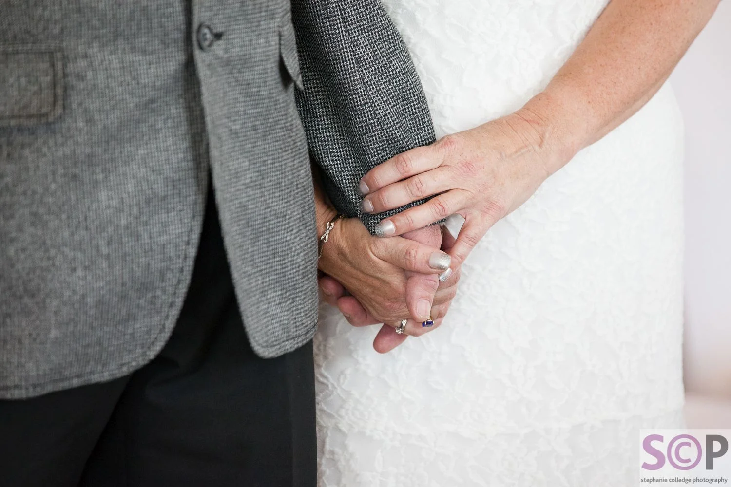 Bride and groom holding hands during the service at the Lea Marston Hotel