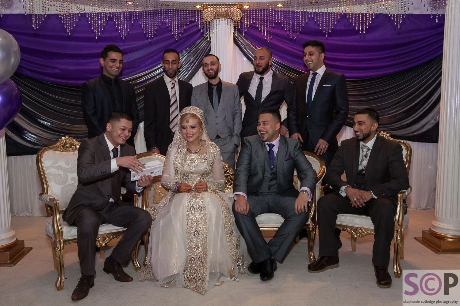 Bride and groom on wedding stage with friends