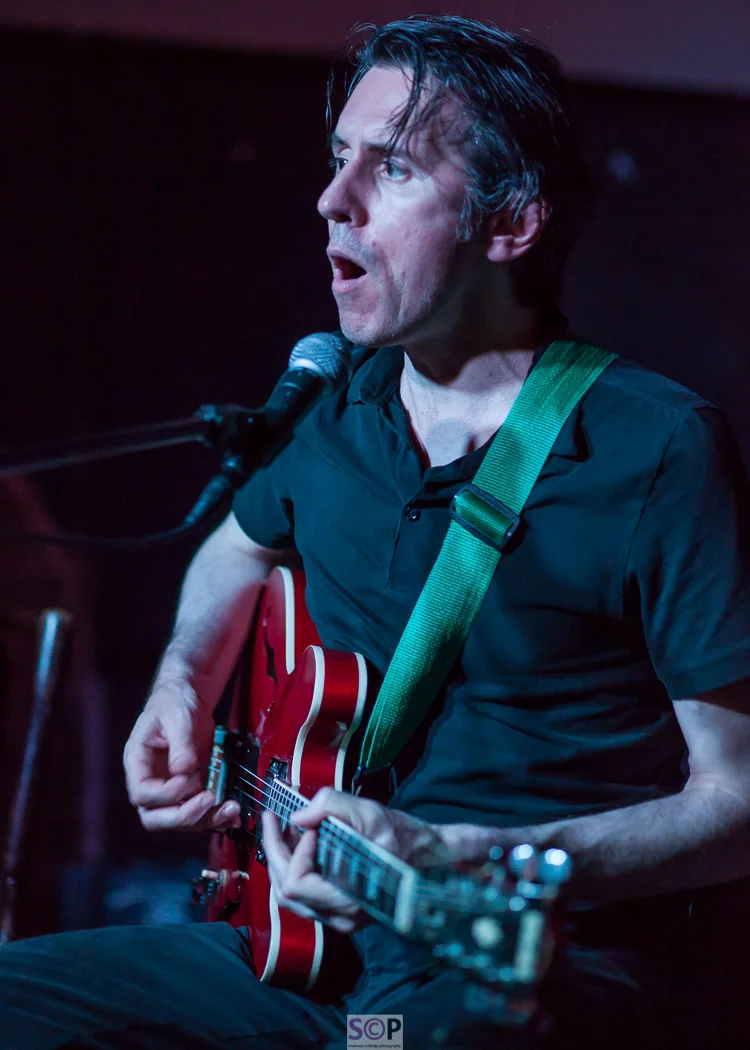Terry Bickers playing guitar and singing as half of Fij and Bickers in Coventry
