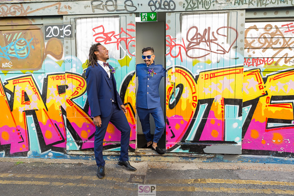 same sex couple with graffiti in brighton