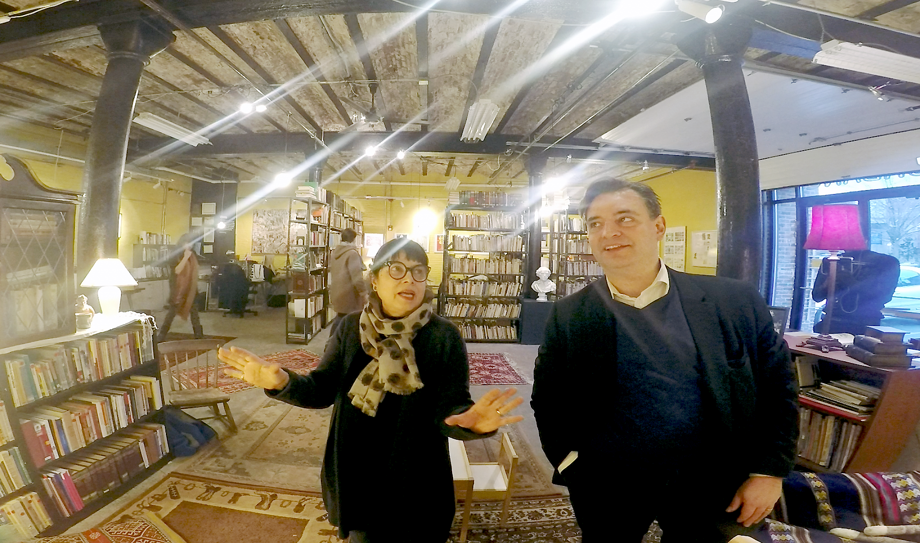 Stella and Pablo view the walls of Librería Donceles.