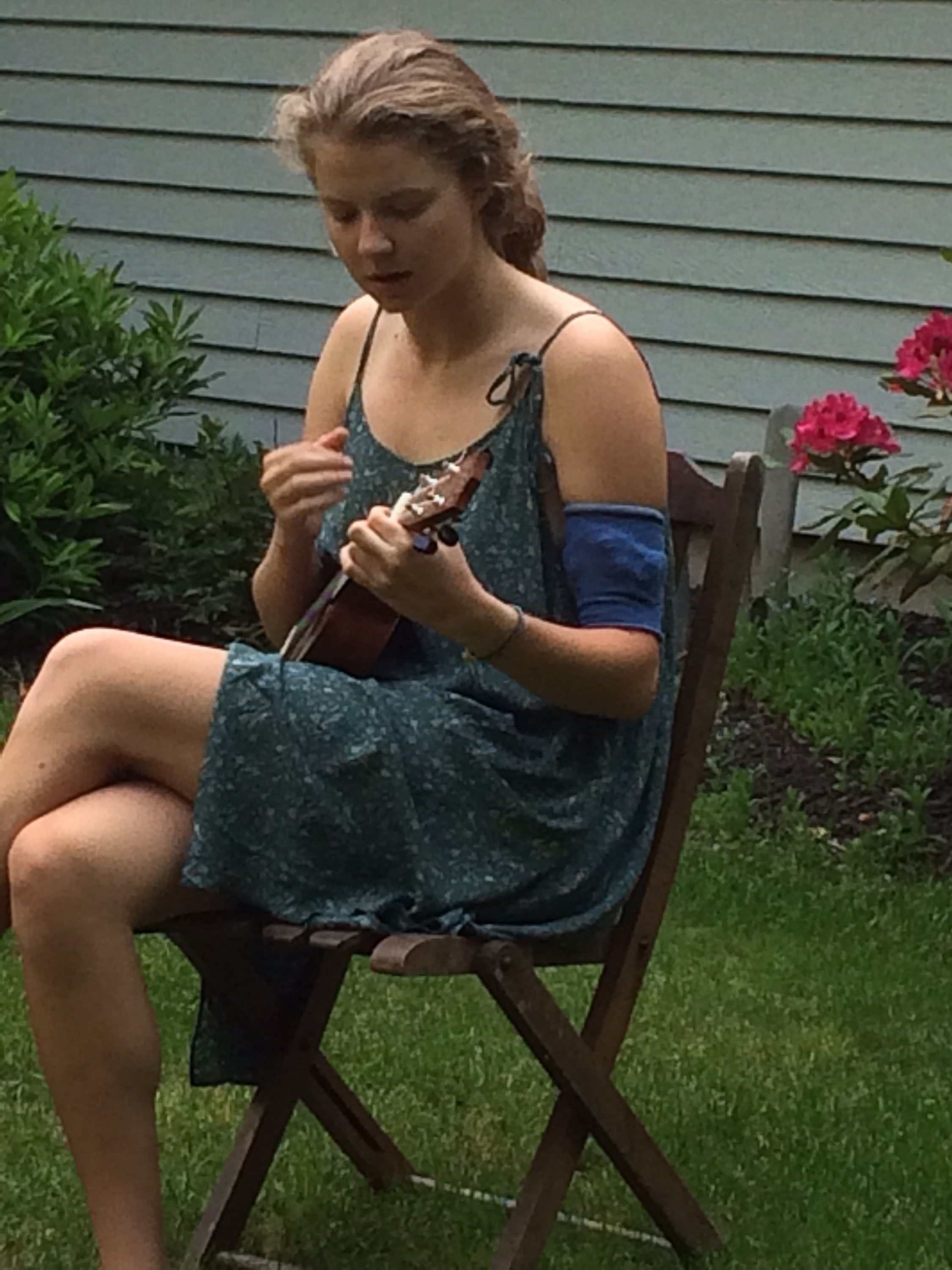 Hogan playing ukelele, with a picc line