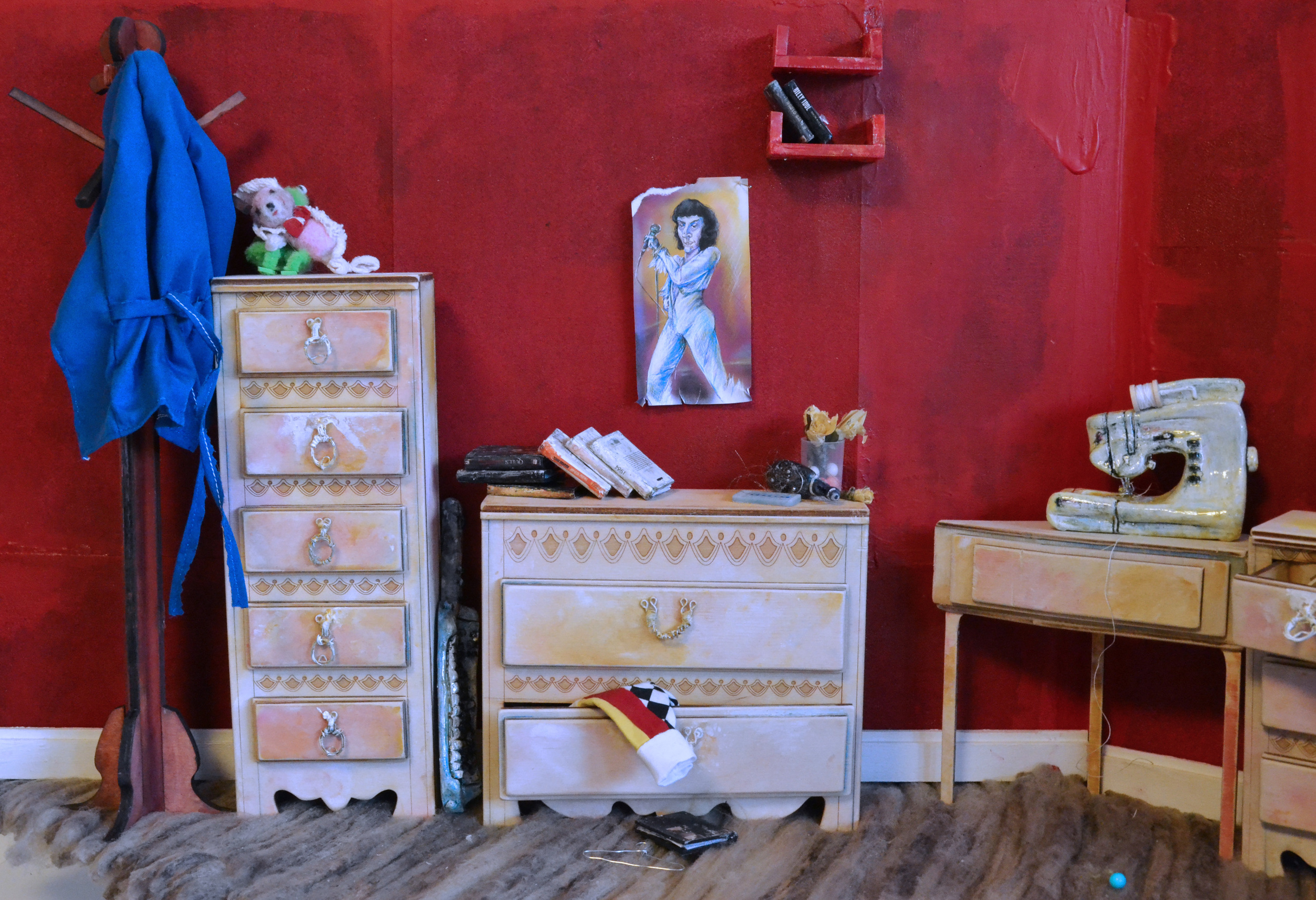  Miniature books and red plastic shelves are laser-cut.  Miniature &nbsp;sewing machine is resin and found object made.  Clothing is hand sewn.  Flowers are hand made using dried flower petals.&nbsp; 