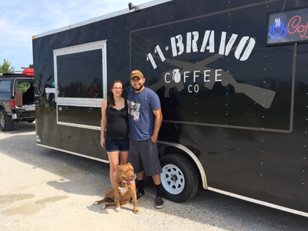 Vic, Erin and their rescue dog, Simba outside the 11 Bravo coffee truck.
