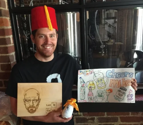 Mike with his gifts and hat at his farewell party.