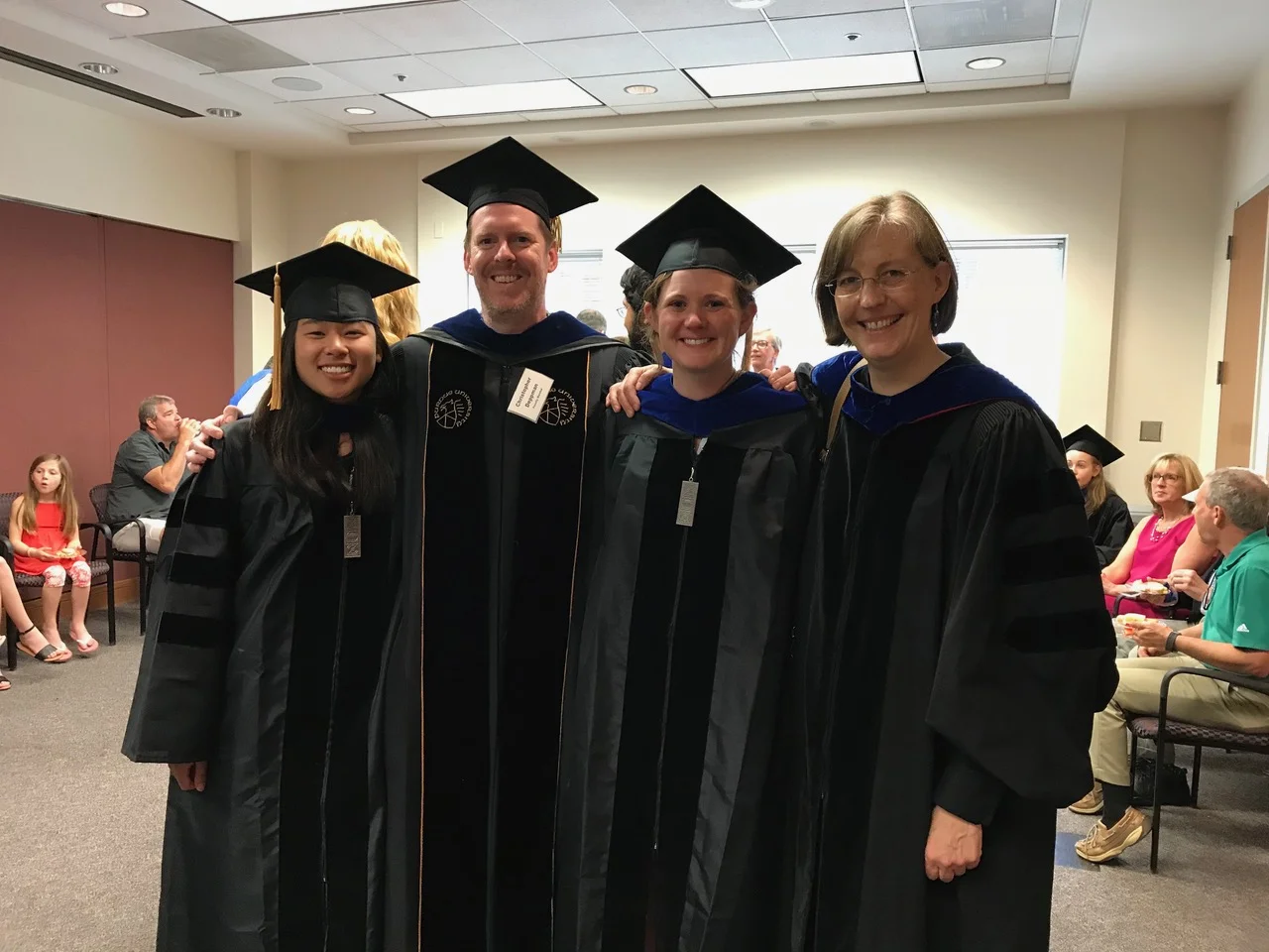 Irene Cheng (far left) and Kelly Barford (third from left) graduate from UVA Neuroscience