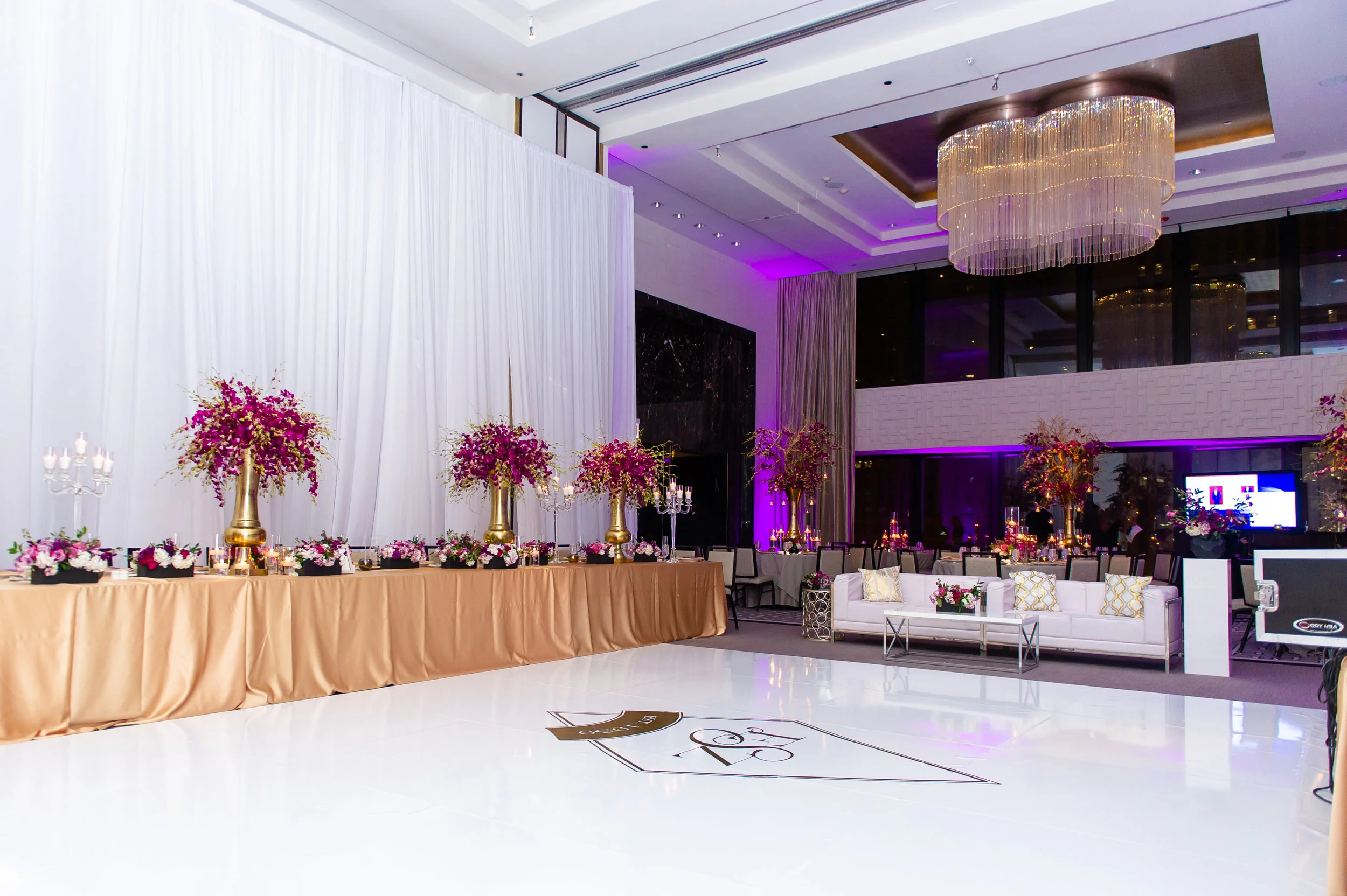   Hotel ballroom with high white ceiling.  