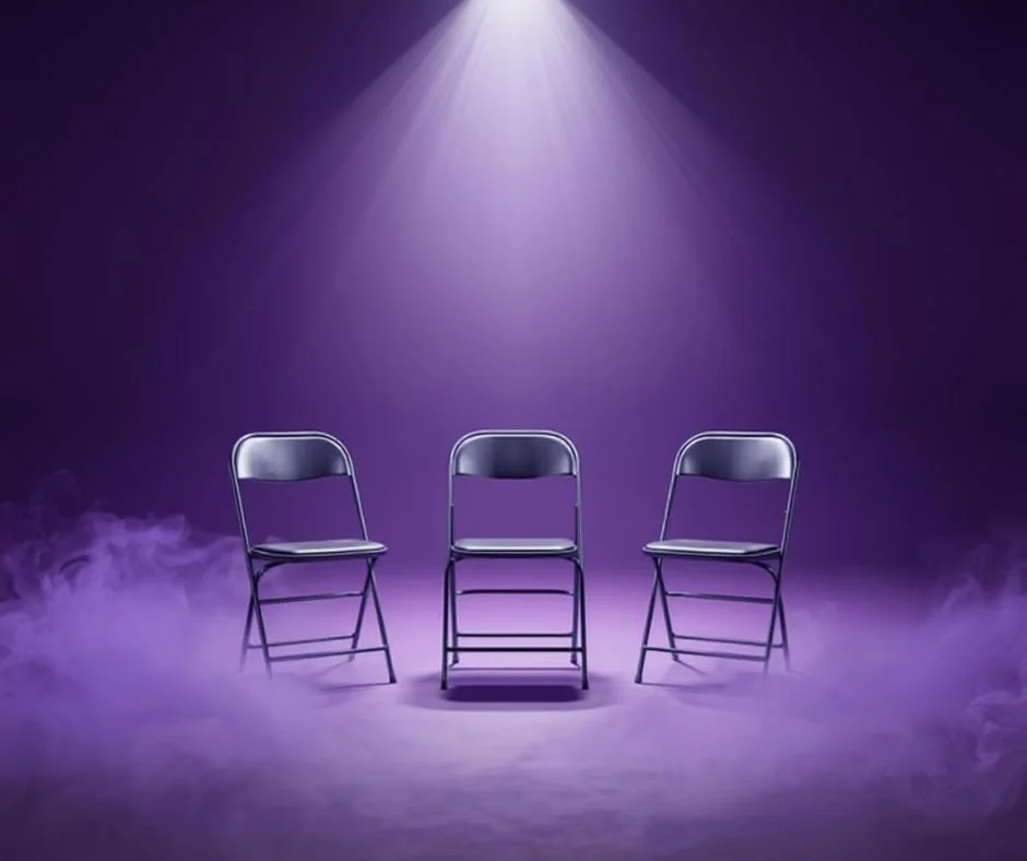 Three chairs under purple stage lighting representing a chair dance class at Violet Flame Studios in Scottsdale, Arizona