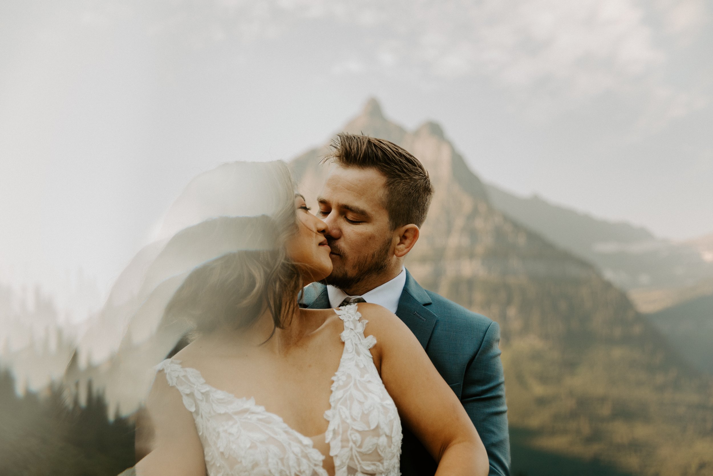 Artistic photo with crystal reflection of couple embracing at Big Bend in Glacier National Park