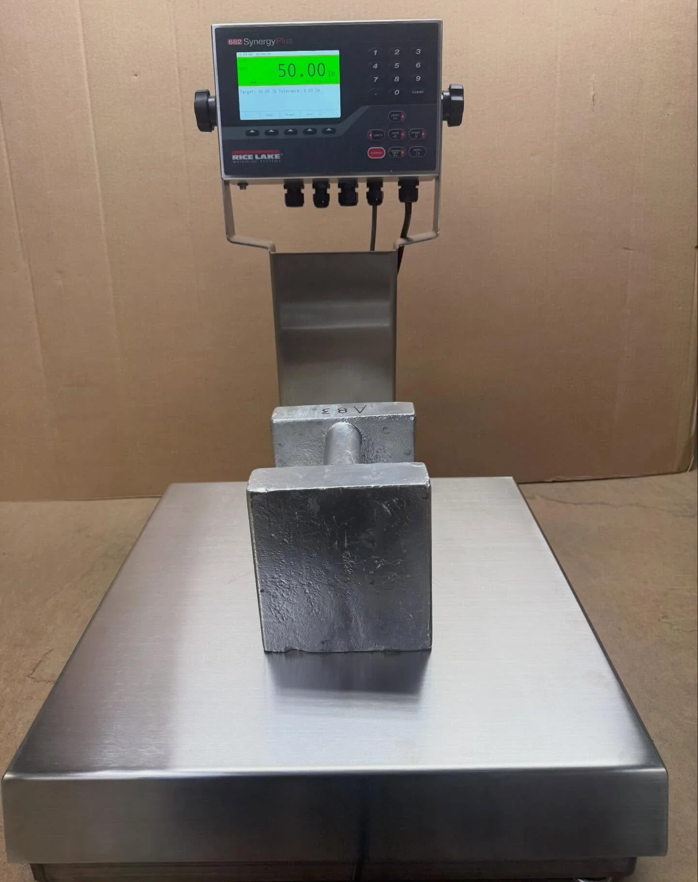 Brand new Rice Lake 682 Synergy Plus digital weigh indicator hooked up to a Benchmark stainless steel bench scale. Not only can you set a target weight, but you can set an under/over zone tolerance too. The LCD color display shows you your settings a