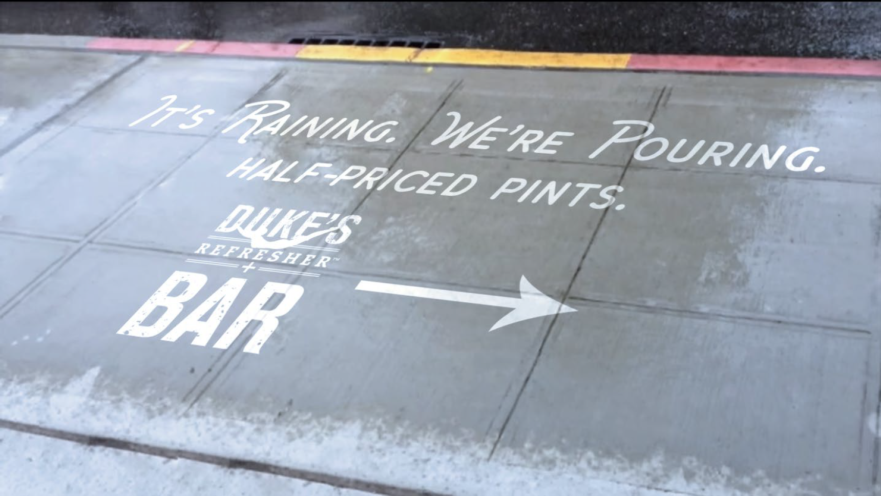  Hydrophobic spray is used to advertise the promotion on the sidewalk near the bar. When it rains the message becomes visible and tells people which way to the bar. 