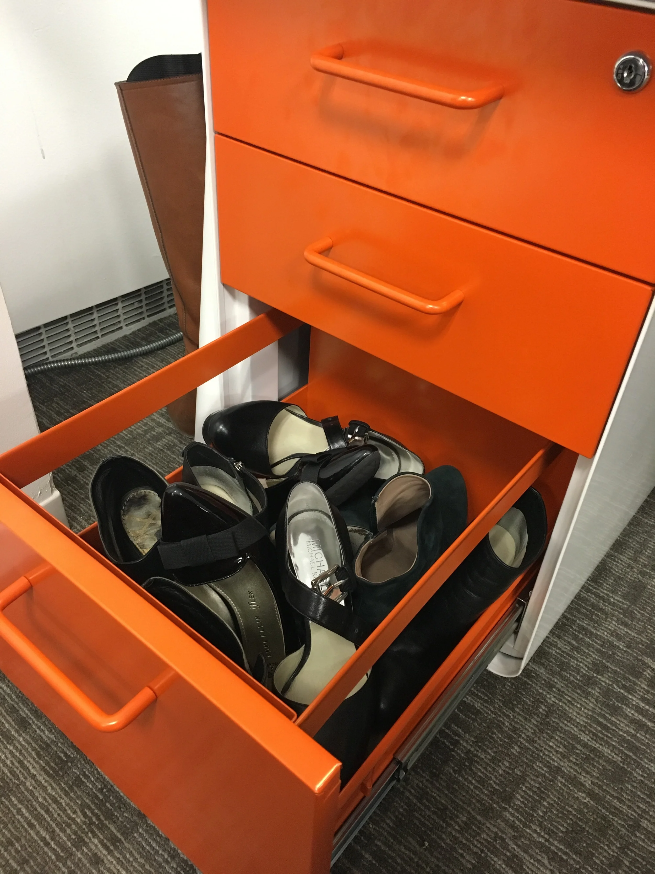 This is my bottom desk drawer at the uptown office. I wasn't lying about stowing away heels! Notice, boots poking around the corner.