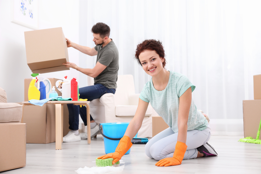 young happy couple cleaning their new house during a move