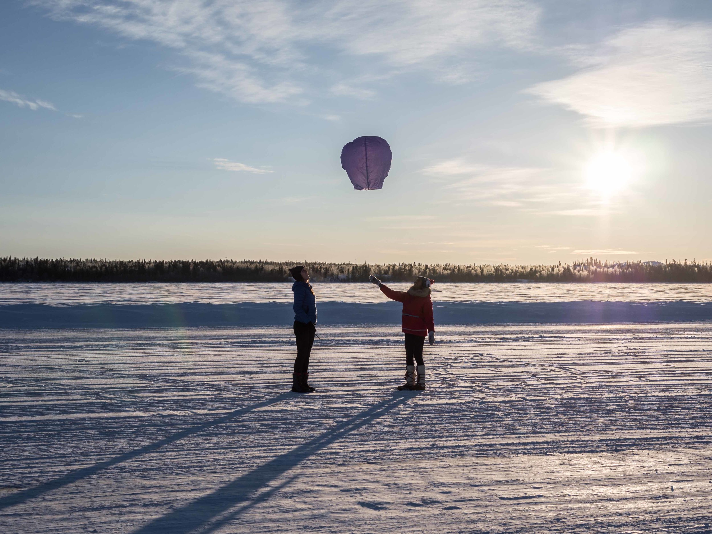 Releasing a paper lantern on the ice road to Dettah. Photo by Sarah-Lacey McMillan.