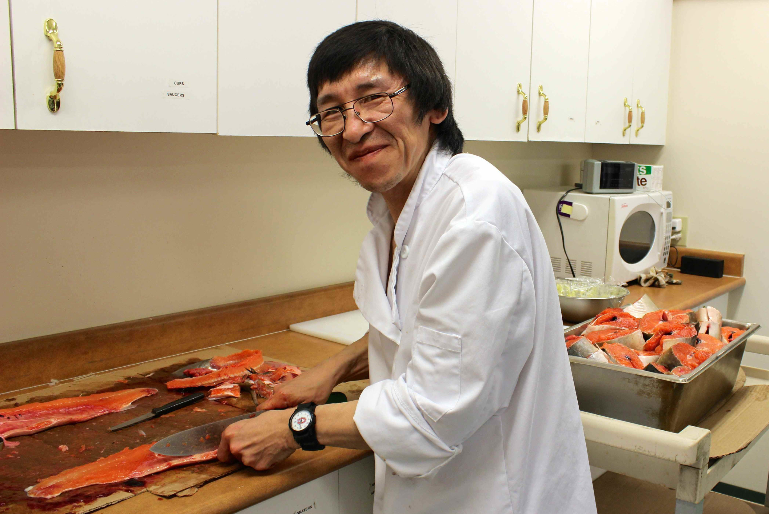 This is Pudloo, a devoted volunteer who prepares local Arctic char filets, bakes homemade dinner rolls, and much more. Photo by Sarah Brandvold.