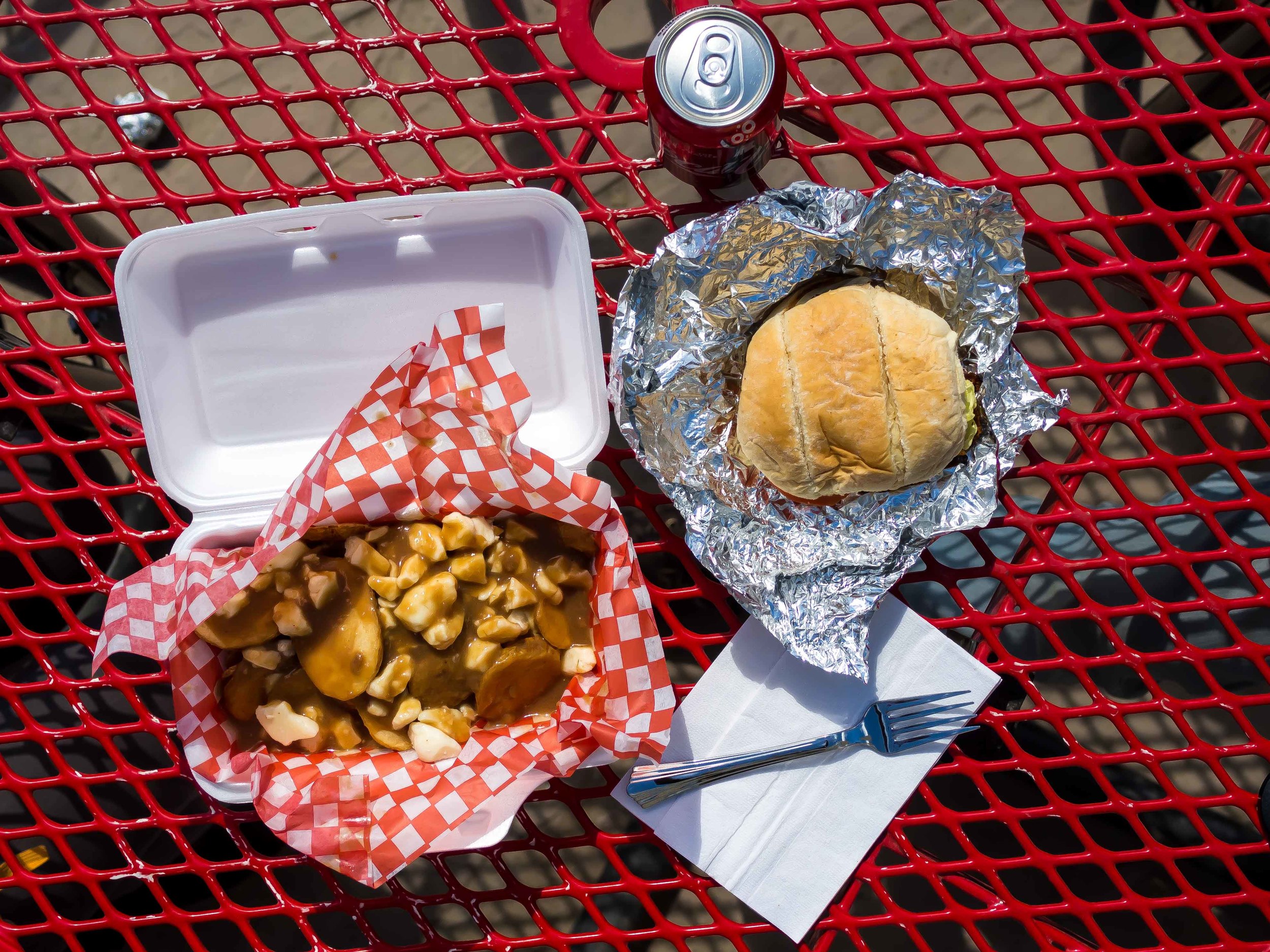 Lunch spread from Curbside Grill: burger, poutine, and a Coke.