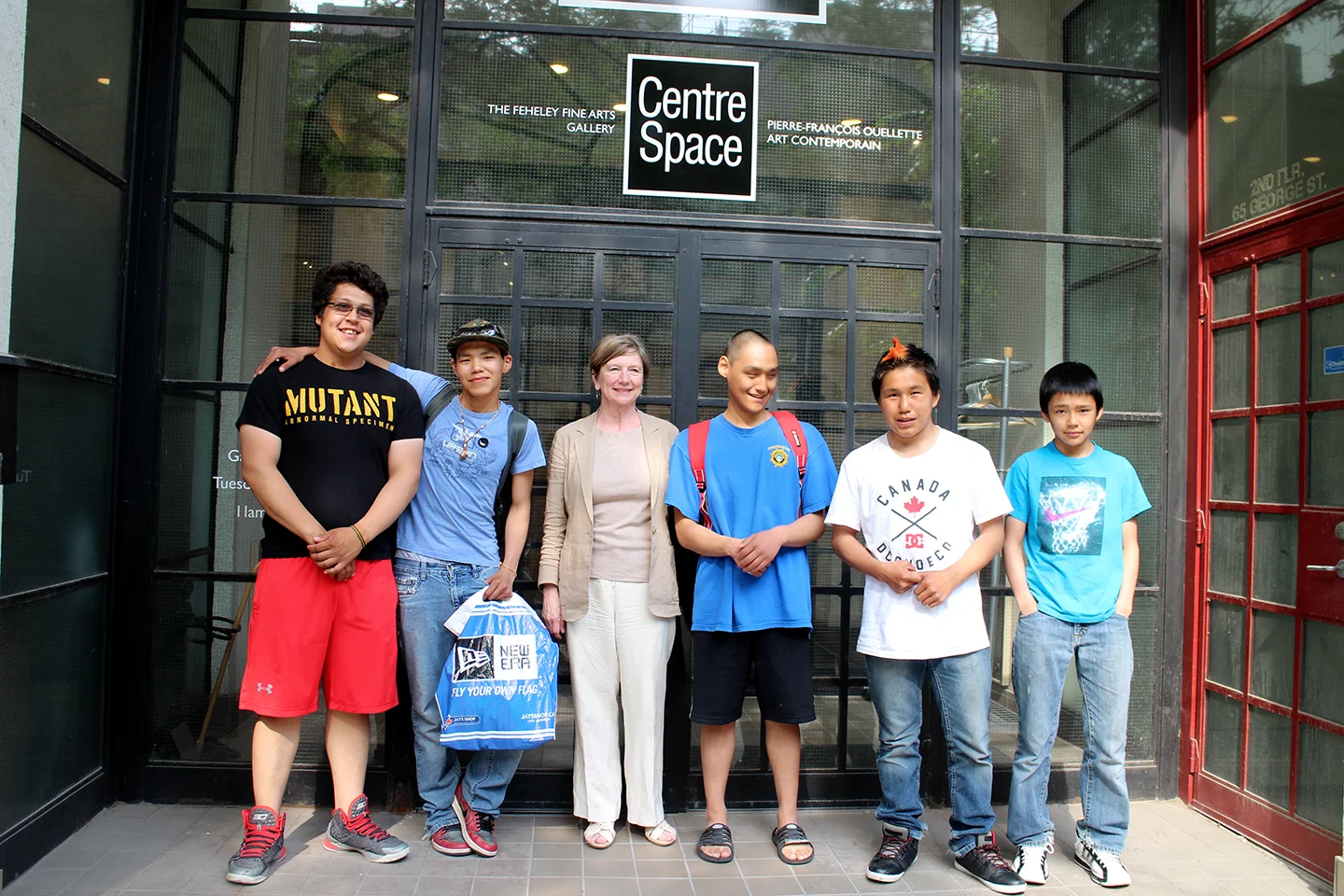 Parr, Cie, Audi, and Latch pose in front of Feheley Fine Arts Gallery with Patricia Feheley. Photo by Alexa Hatanaka.