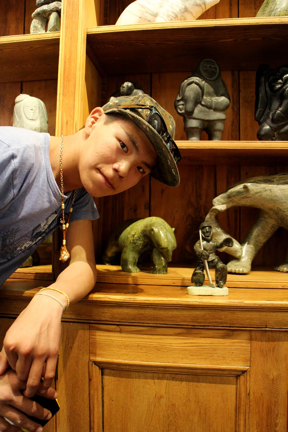 Parr with a carving made by his father, at the Feheley Fine Art Gallery. Photo by Alexa Hatanaka.