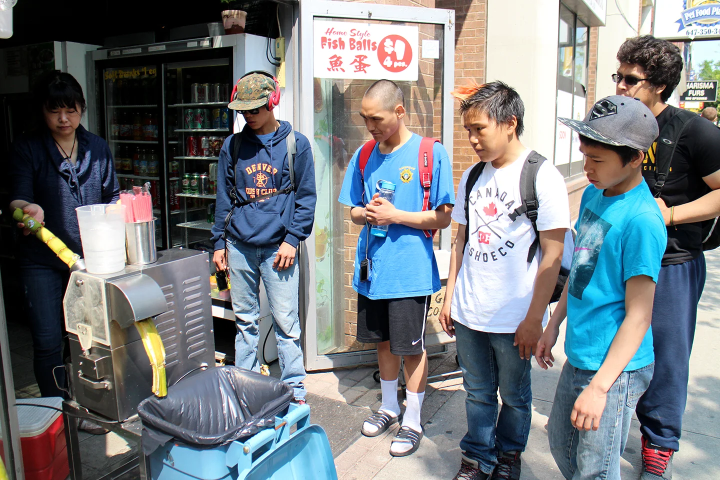 The boys try sugarcane juice in Chinatown. Photo by Alexa Hatanaka.