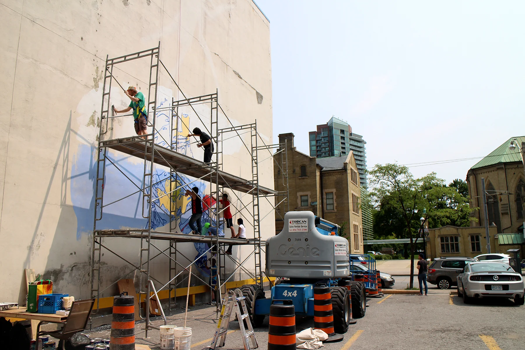 Painting two stories above the ground. Photo by Alexa Hatanaka.