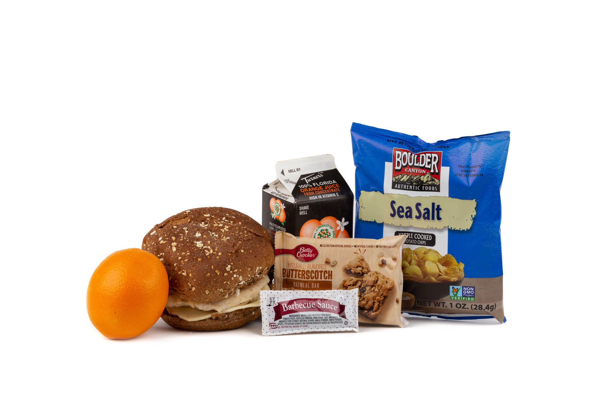 MK02 - Fresh Chicken Barbeque Grilled Chicken Breast/ Pepper Jack Cheese on Wheat Bun BBQ Sauce Packet Orange Juice Chip Potato Bag Boulder Canyon w/ Sea Salt Juice Orange Butterscotch Oatmeal Bar