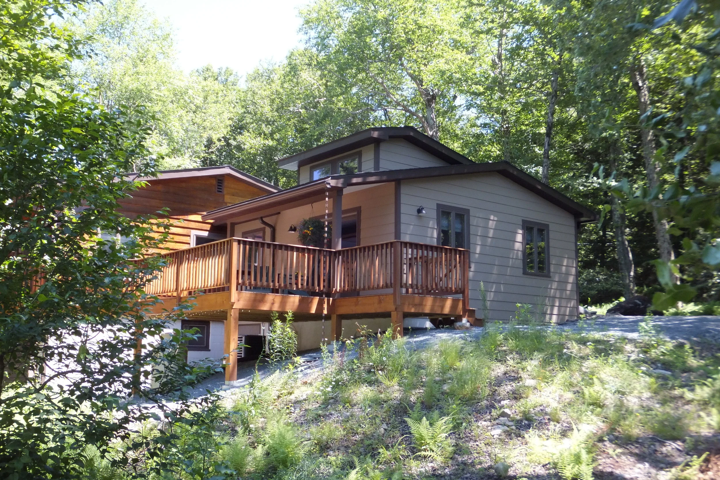  The new master bedroom addition has its own lake-facing deck, connected to the main deck via a bridge.  