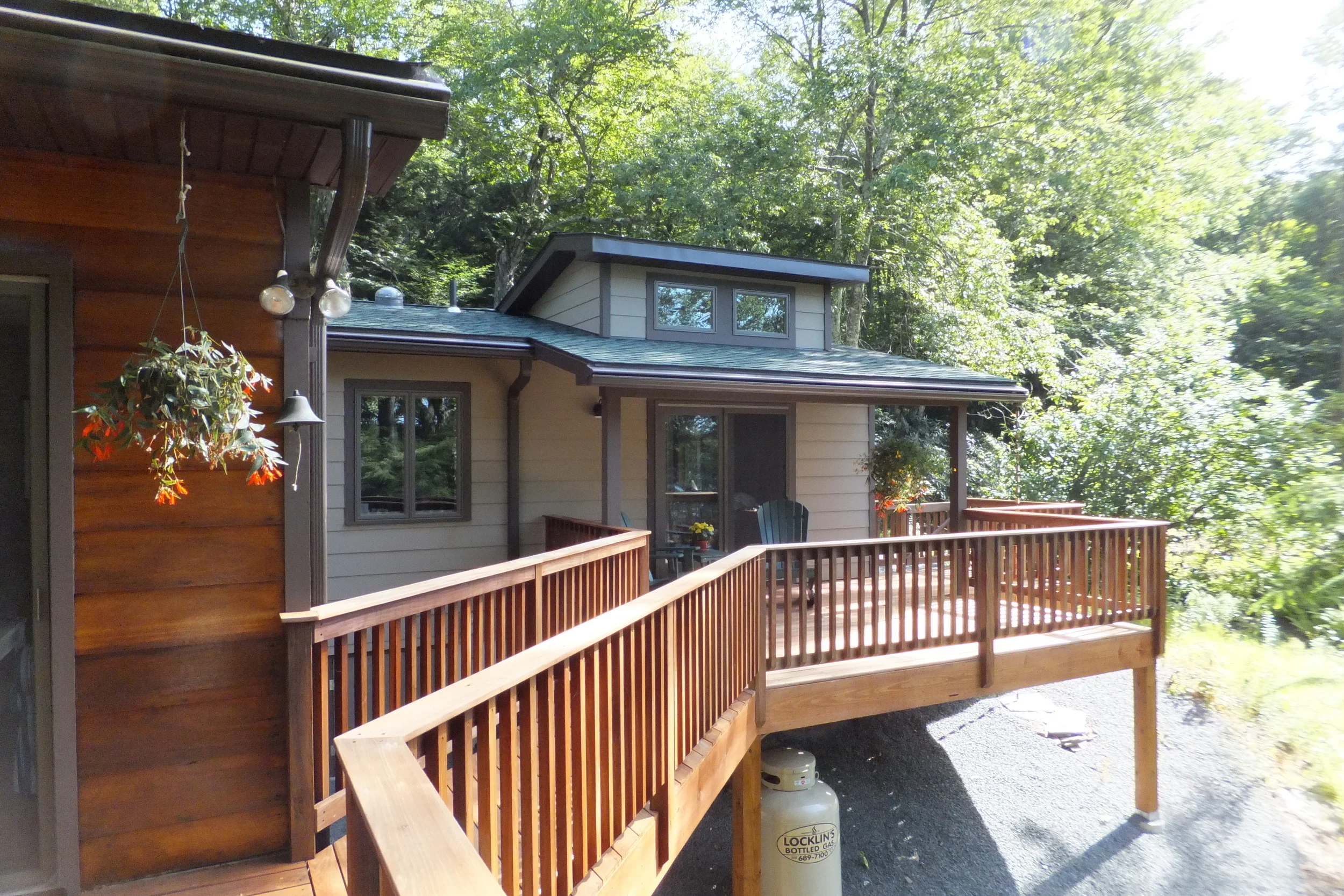  The new master bedroom addition has its own lake-facing deck, connected to the main deck via a bridge.  