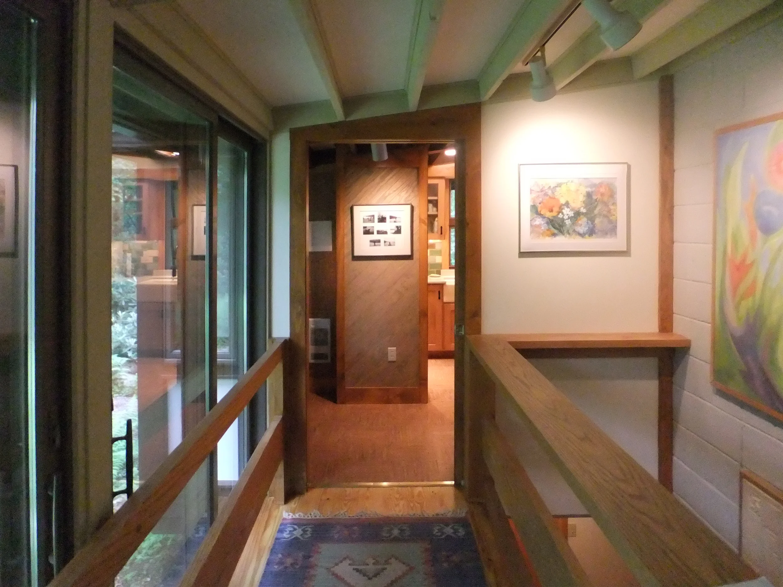  The new kitchen features a cabinet-run end-wall, centered on the new pocket door that separates the kitchen from the entrance hall.  