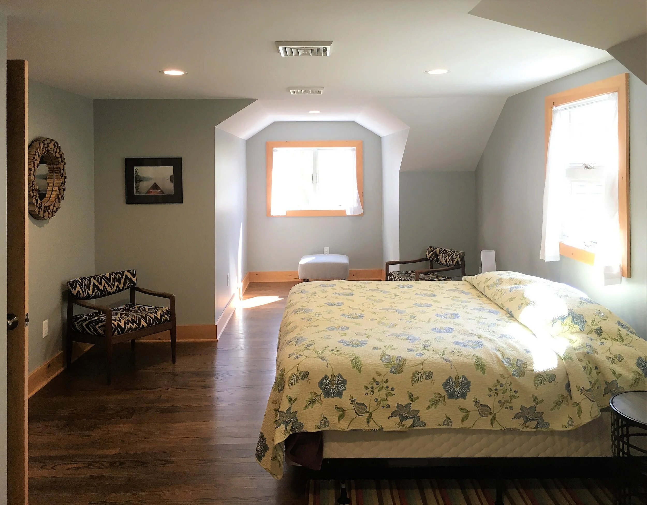  This 2nd floor bedroom was extensively remodeled. It was previously a loft overlooking the living room but is now a large private bedroom with three exposures including a new gable with window overlooking the lake.  