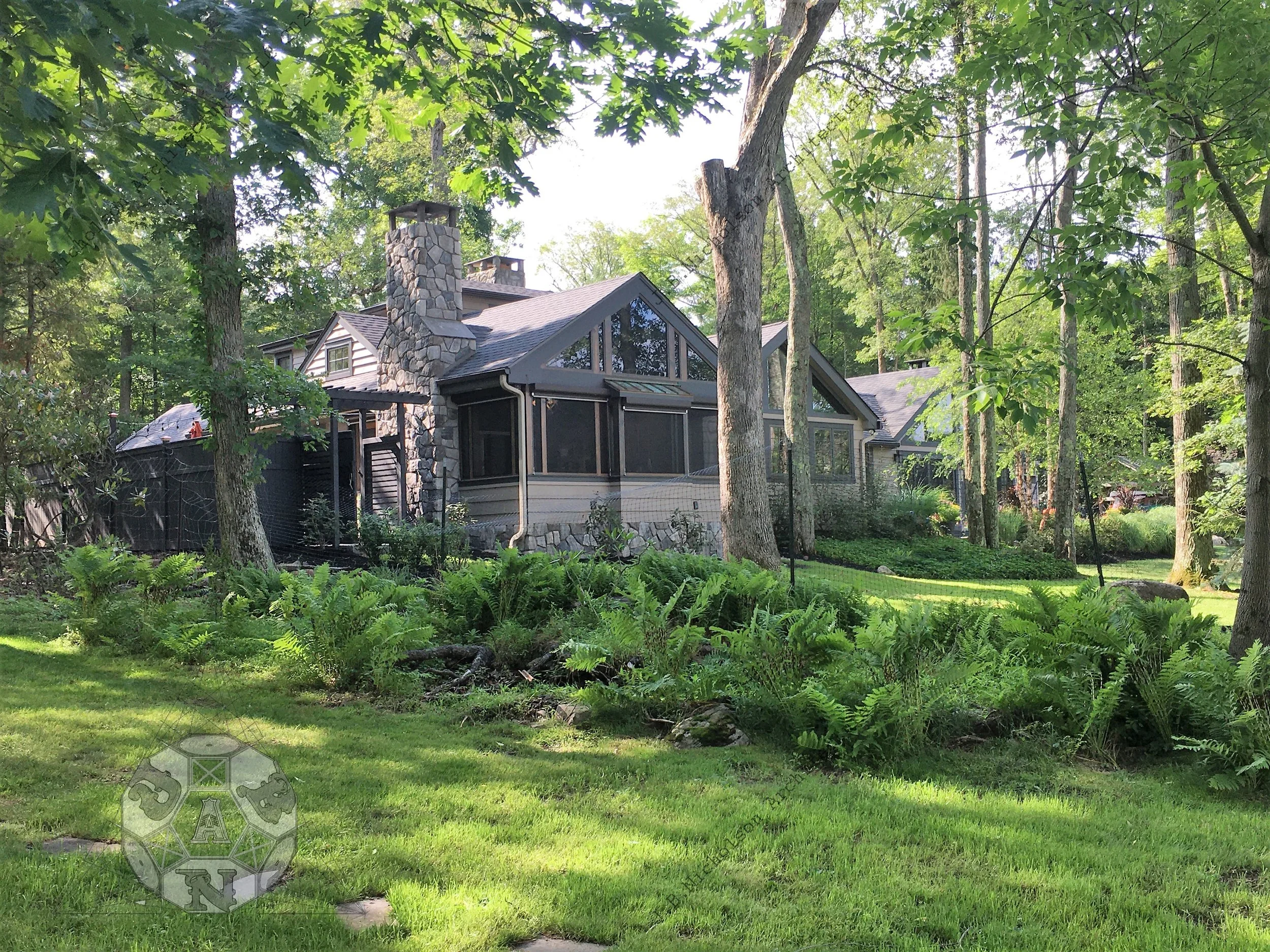  View from the lake shore toward the house with the new addition in the foreground.  