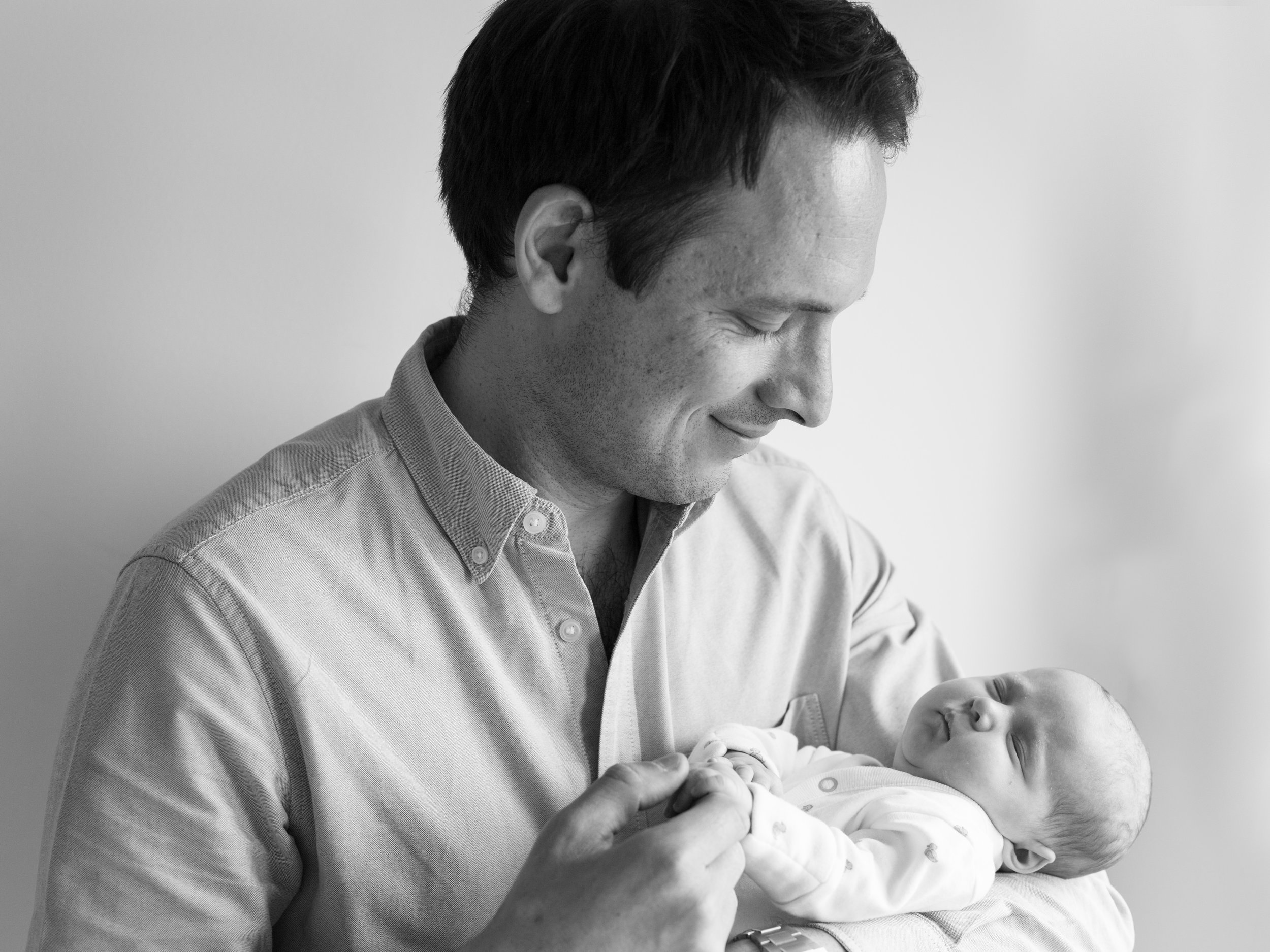 Father and new born baby black and white photography