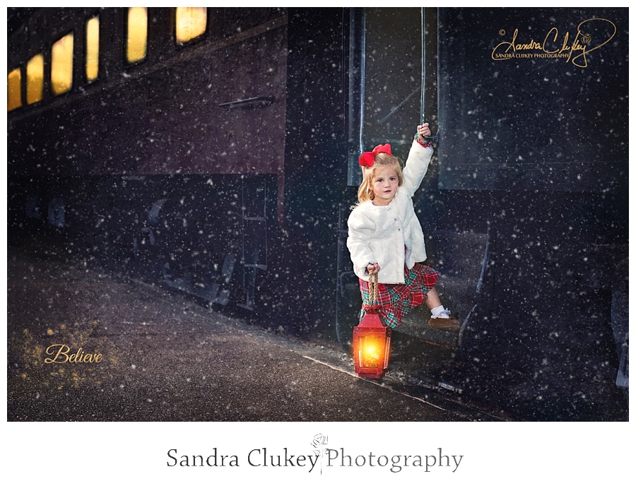 Adorable girl with lantern boards train