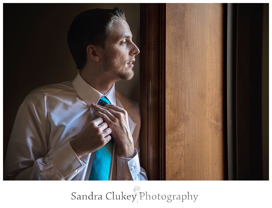 Groom looking out window