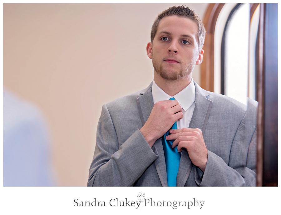 Groom fixes blue tie