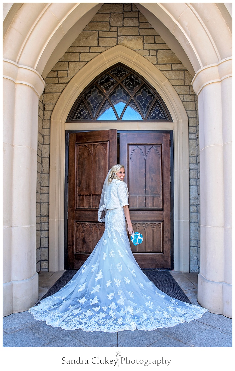 Bride's cathedral length train at chapel doors