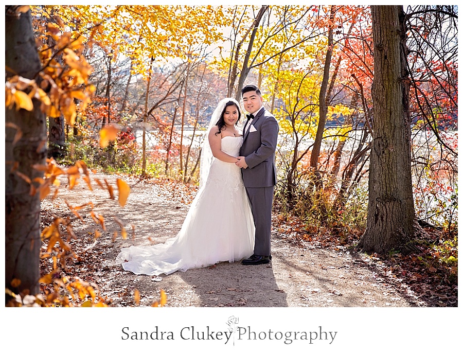 Stunning couple on tree lined path during first look 